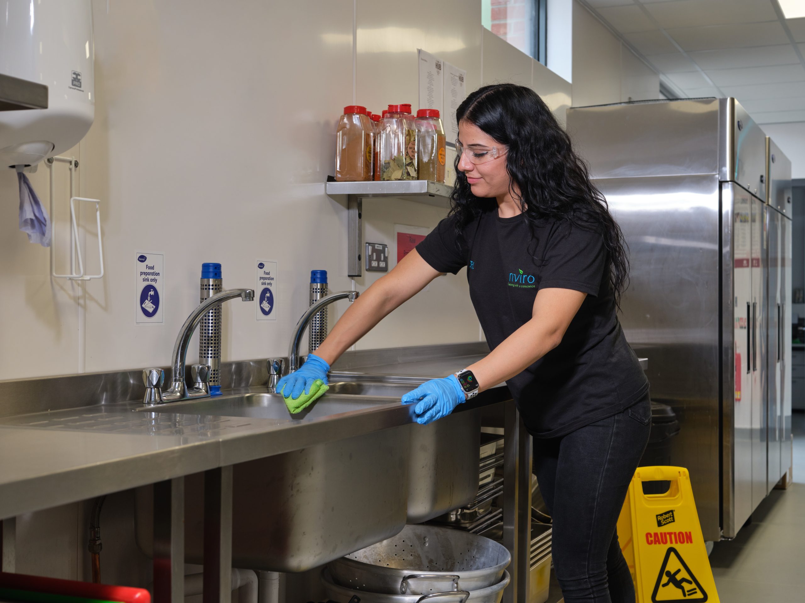 Cleaner wiping the surface in kitchen area