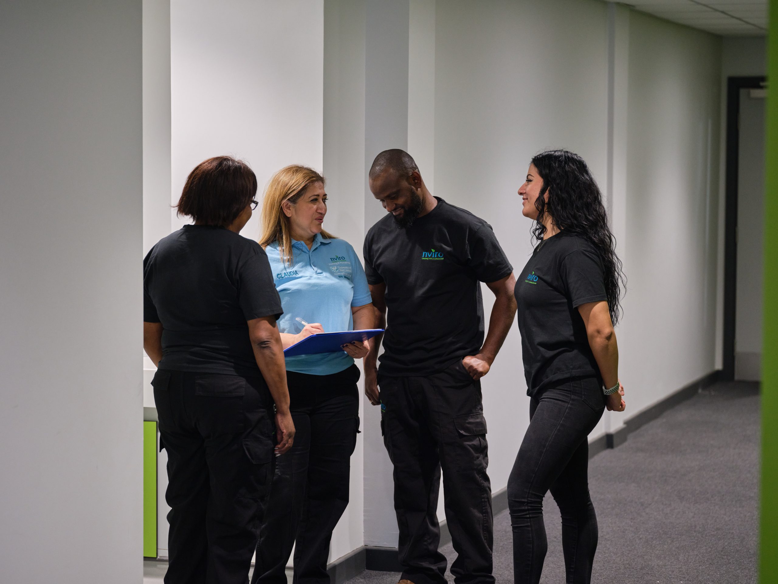 Cleaners together talking in a hallway